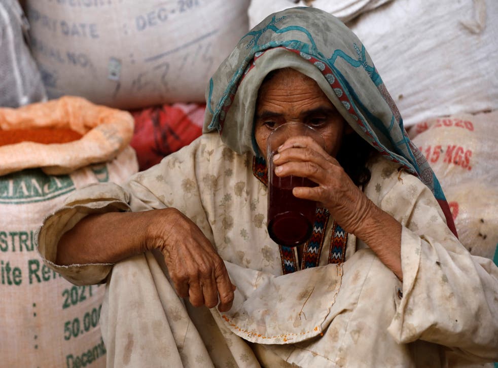 <p>A woman drinks a plum and tamarind drink to cool off </p>