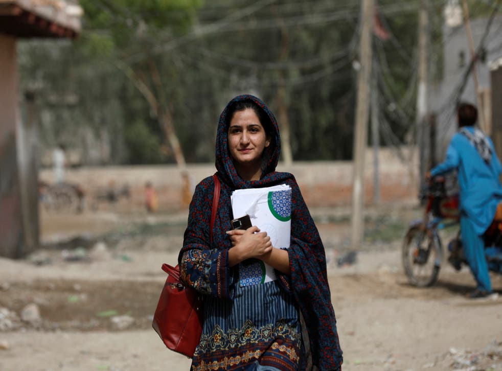 <p>Liza Khan, project manager at the Community Development Foundation (CDF), walks to her office</p>