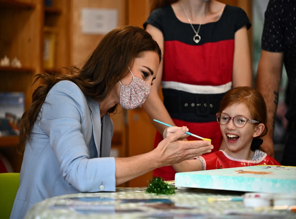 The Duchess of Cambridge puts a hand print on a canvas next to Willow Bamber during a visit to East Anglia’s Children’s Hospices (EACH) in Milton (Ben Stansall/PA)