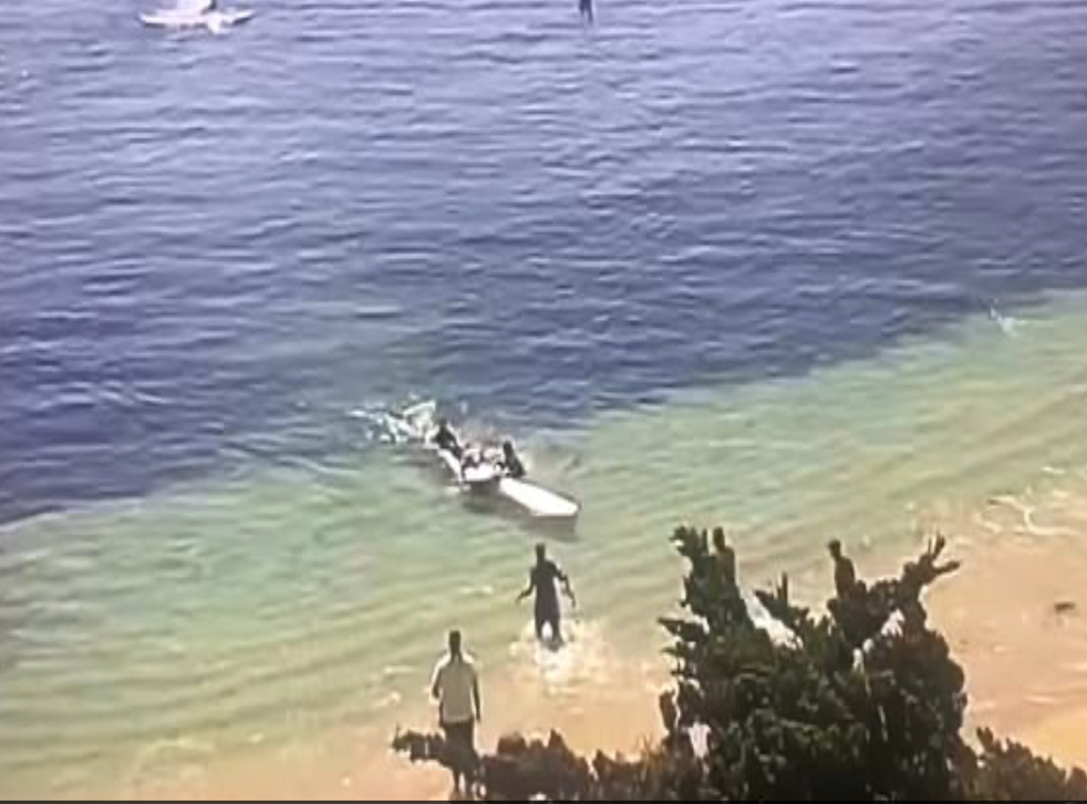 <p>Steve Bruemmer is brought into shore after being attacked by a shark</p>