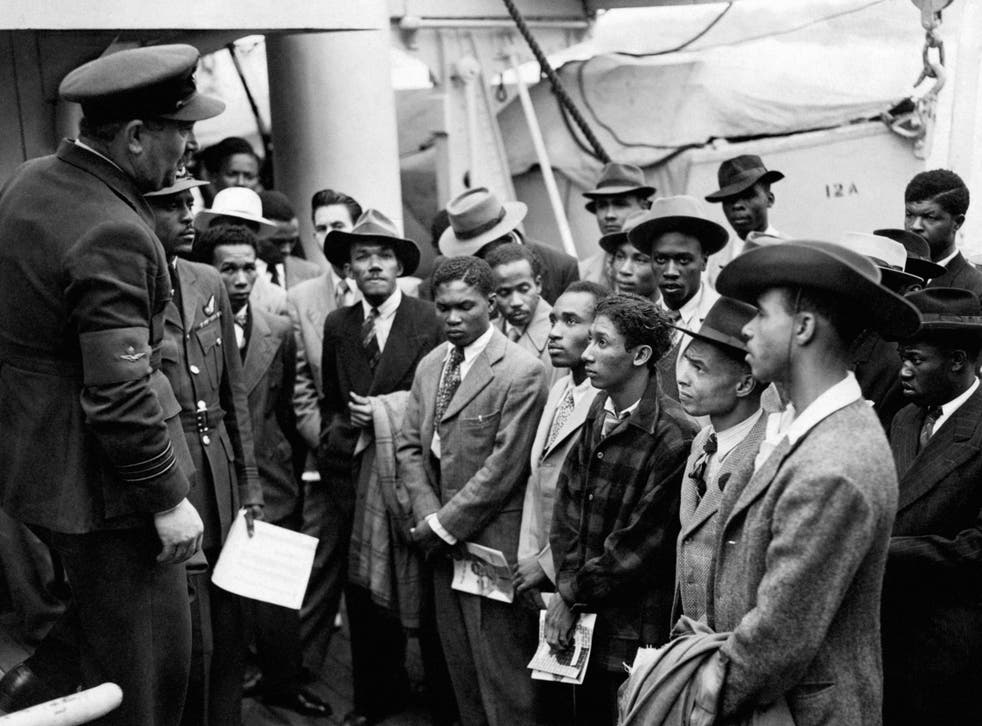 Jamaican immigrants welcomed by RAF officials from the Colonial Office after the ex-troopship HMT Empire Windrush landed them at Tilbury (PA)