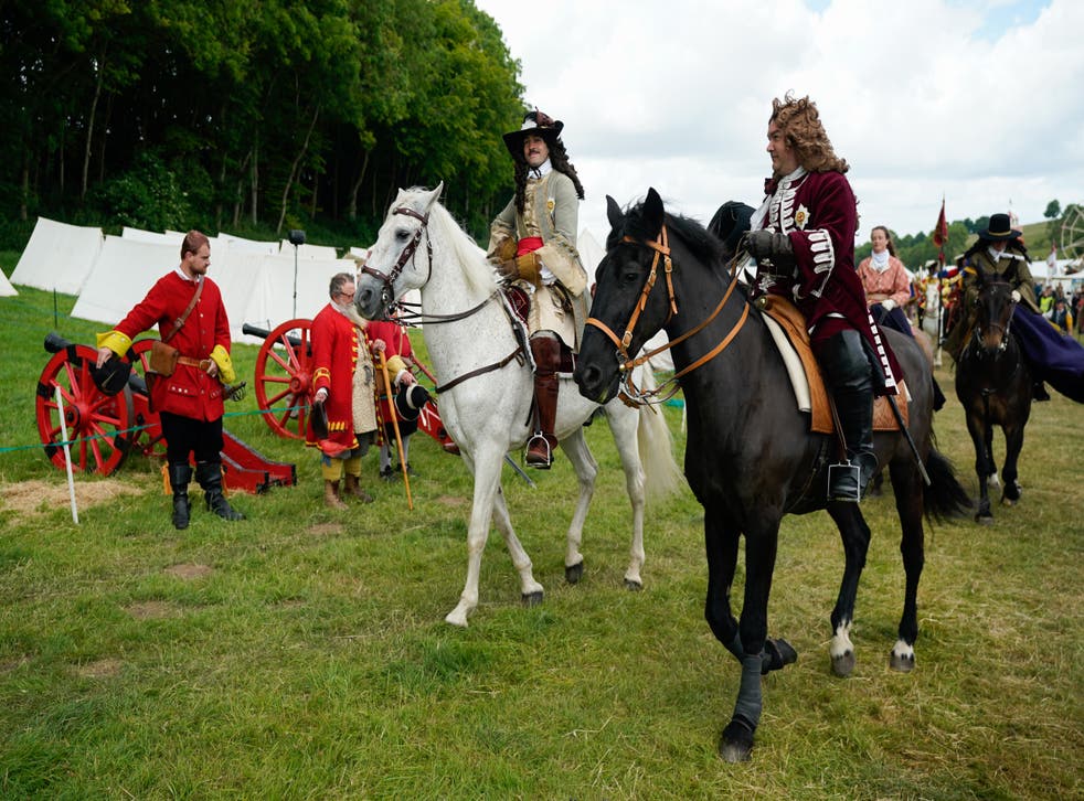 Members of the Wimborne Militia provide a guard of honour as a Restoration-era pageant makes it way to the arena (Andrew Matthews/PA)