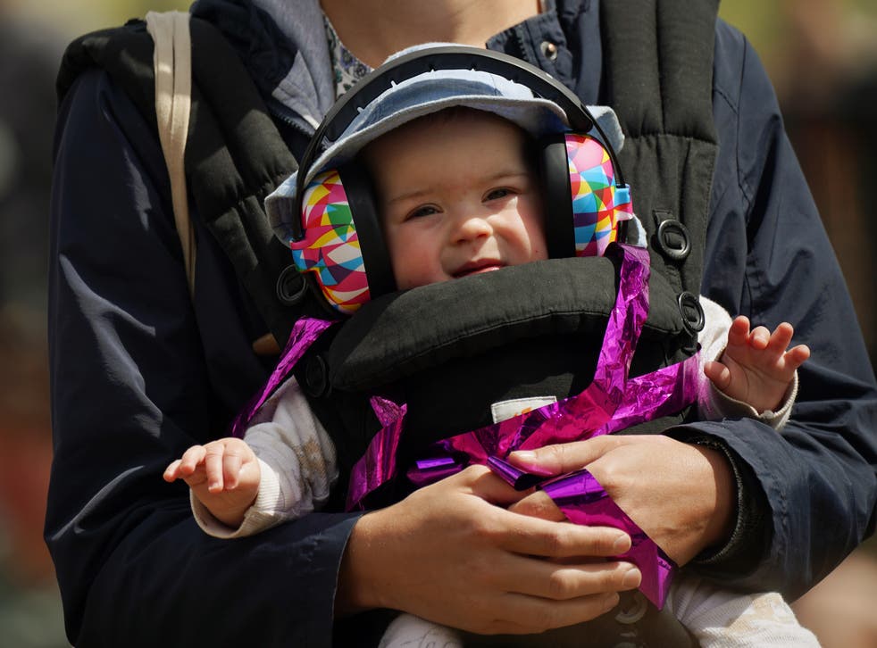 A young fan had ear protectors on for the brass music from the Black Dyke Band on Sunday afternoon (Yui Mok/PA)