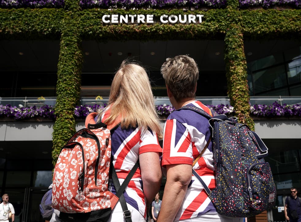 Spectators wearing Union Jack style T-shirts look towards Centre Court ahead of day one of the 2022 Wimbledon Championships (Aaron Chown/PA)