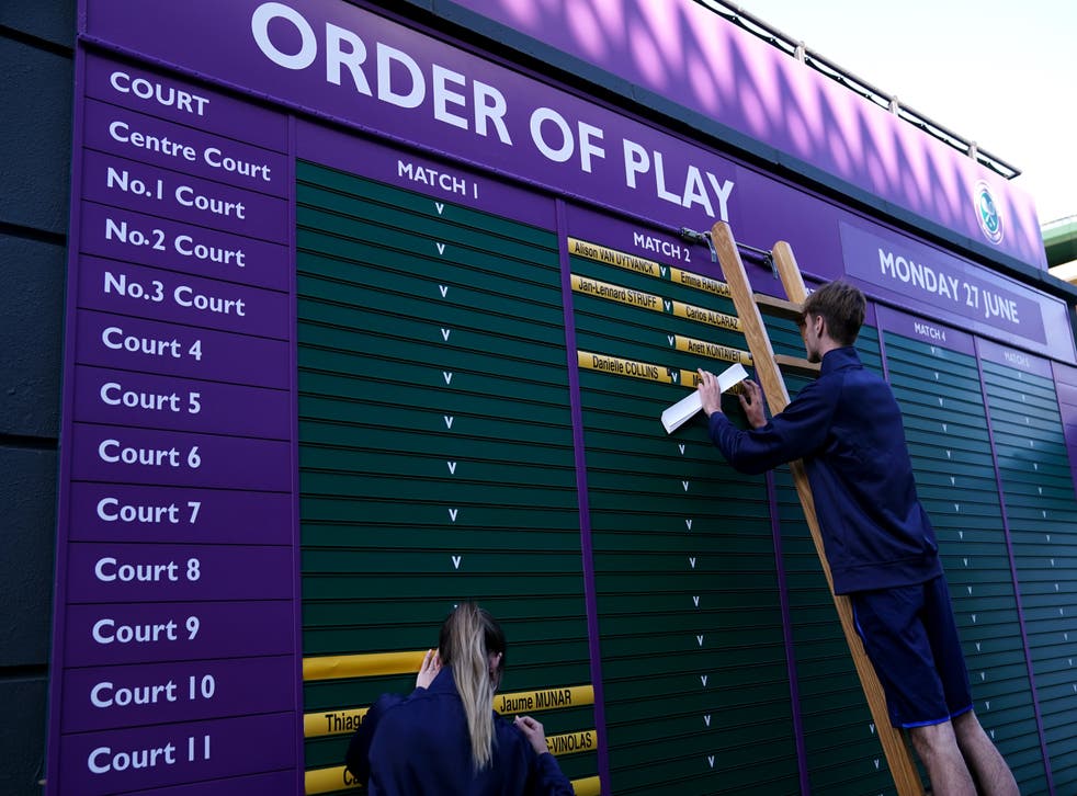 Ground staff update the order of play for day one of Wimbledon 2022 (John Walton/PA)