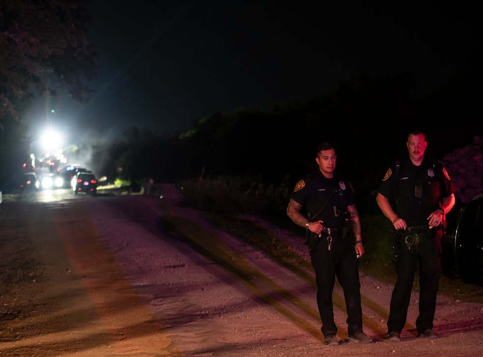 <p>Police guard an area at the scene where a tractor-trailer was discovered with migrants inside outside San Antonio, Texas on 27 June 2022</p>