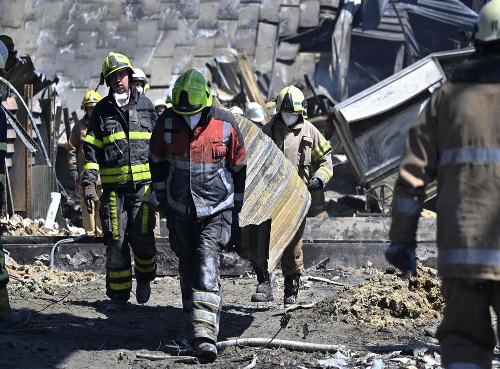 <p>Workers are seen clearing the rubbles of the Amstor mall, after it was hit by a Russian missile strike according to Ukrainian authorities in Kremenchuk</s>