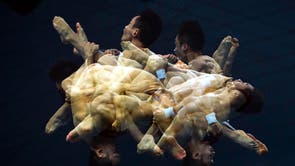 A multiple exposure picture of Hao Yang and Junjie Lian competing in the men’s Synchronized 10m Platform Diving preliminaries of the FINA World Aquatics Championships at Duna Arena in Budapest