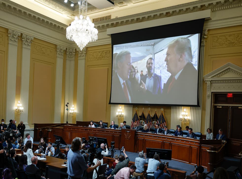 <p>An image of former President Donald Trump talking to his chief of staff Mark Meadows is screened as Cassidy Hutchinson testifies to the committee </p>