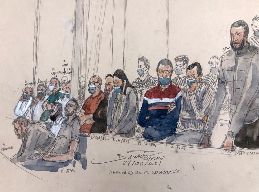<p>This court sketch shows defendant Salah Abdeslam (right) standing next to the 13 other defendants in front of the Paris court </p>