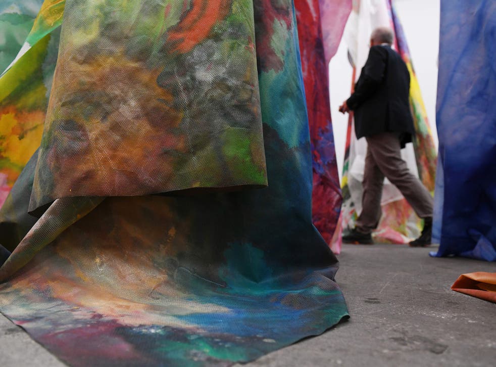 <p>A man walks past an untitled artwork by Sam Gilliam during Art Basel in 2018 </p>