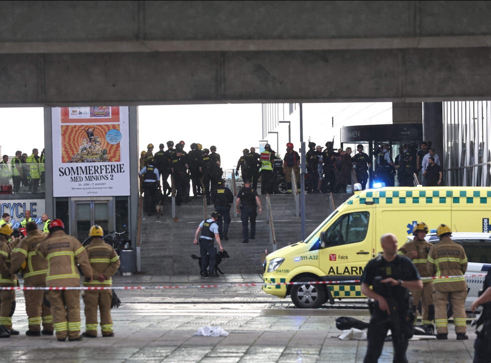 <p>Police officers and rescuers are seen in front of the mall</p>