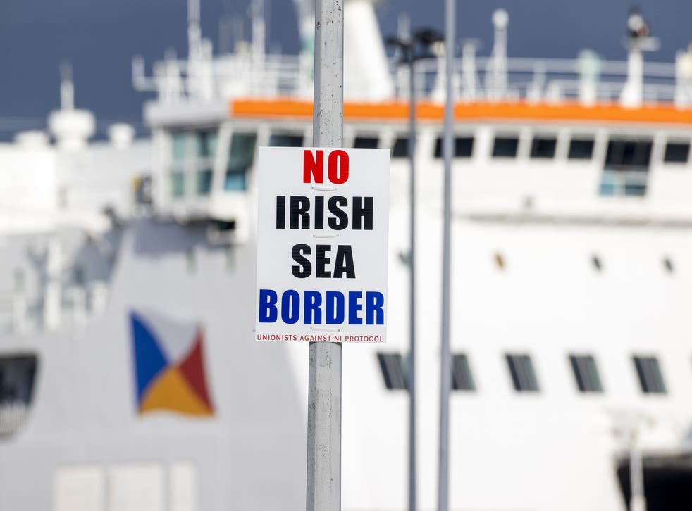 A sign on a lamppost outside Larne Port with the word ‘No Irish Sea Border’ (PA)