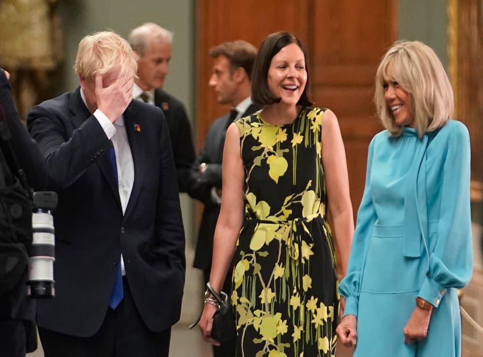 <p>Boris Johnson speaks with Annik Penders (centre), the wife of Belgian premier Alexander De Croo, and Brigitte Macron, wife of the French president in Madrid</p>