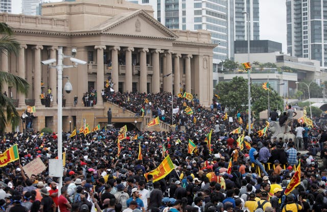 Demonstrators celebrate after entering into the Presidential Secretariat, after President Gotabaya Rajapaksa fled, amid the country's economic crisis, in Colombo, Sri Lanka
