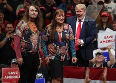 Bizarre moment Trump pulls fans on stage wearing shirts of his face and says ‘give ‘em to me right now’