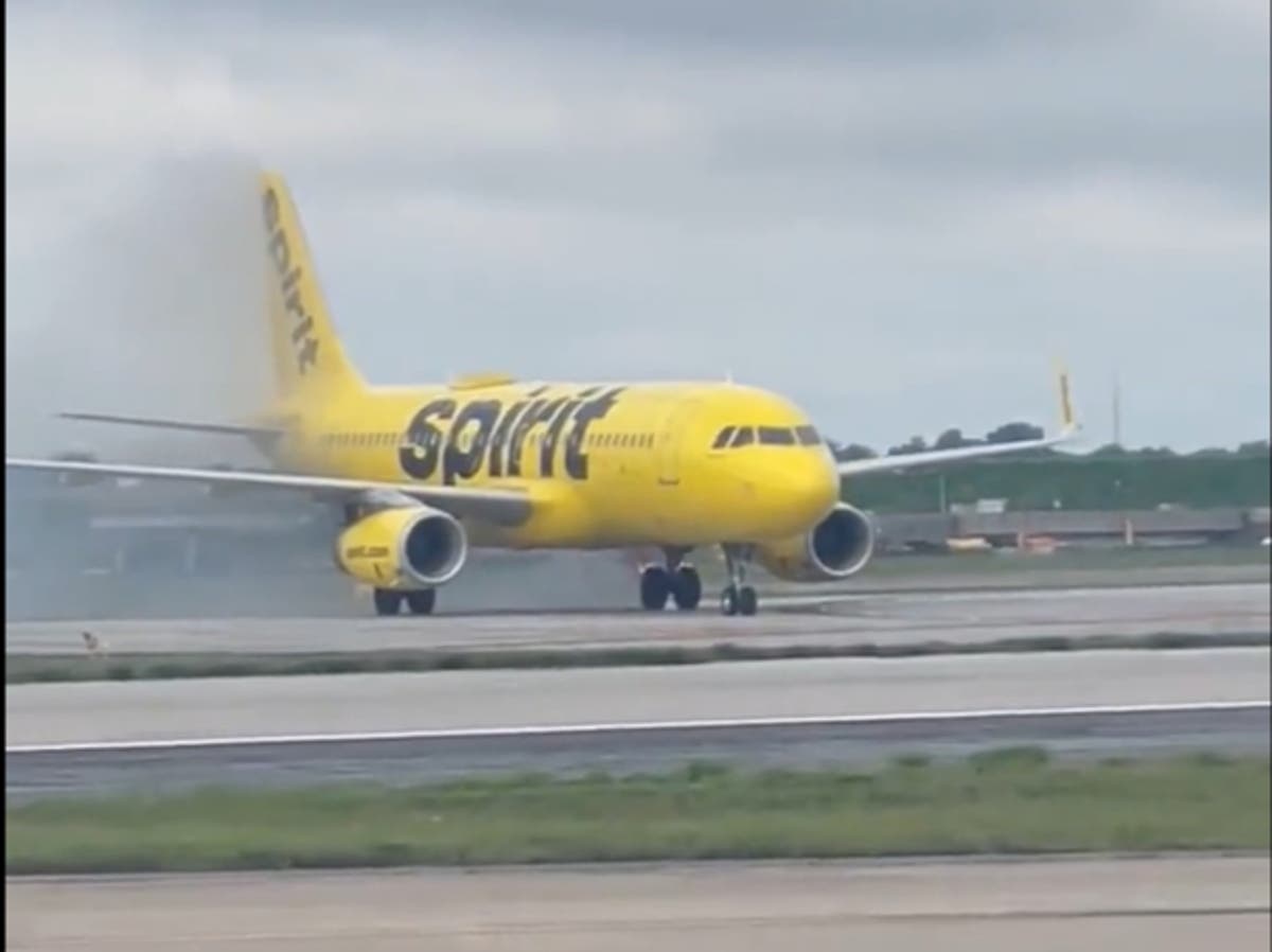 Spirit crew tell passengers to stay seated as plane catches fire on Atlanta landing