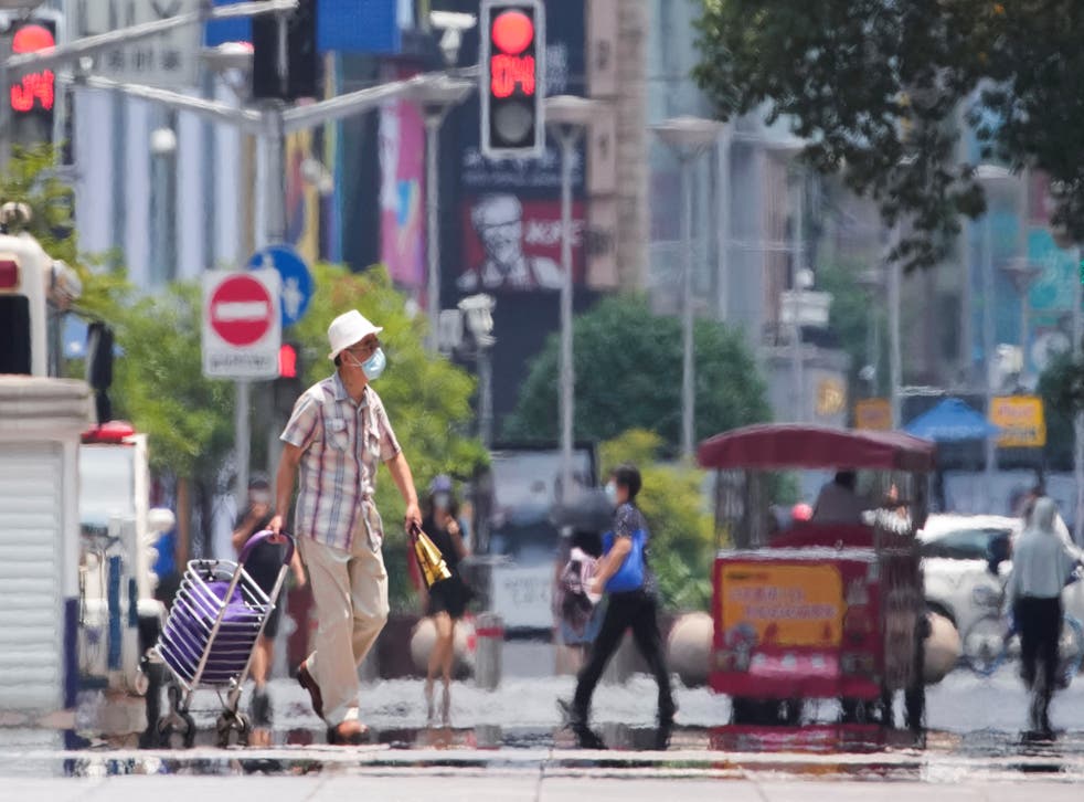 <p>Pedestrians during a heatwave in Shanghai in July</bl>