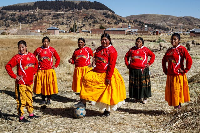 A football team of Aymara indigenous women pose for a picture before a championship in the Aymara district of Juli in Puno, southern Peru