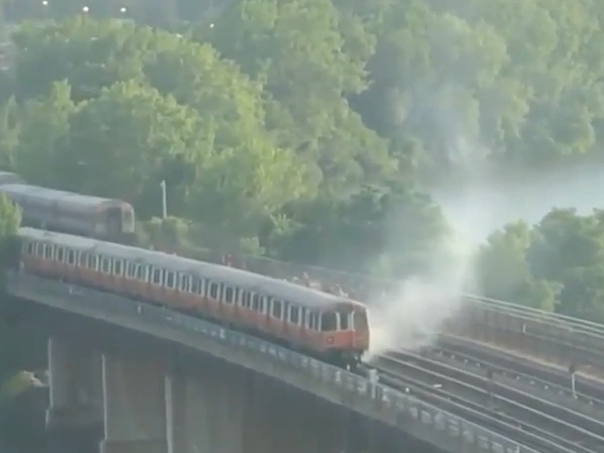 Passenger jumps from bridge into river after train catches fire near Boston
