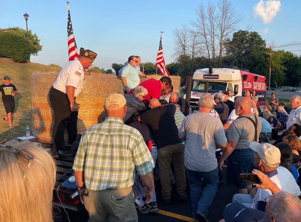 <p>In this photo provided by Ian Winner, people subdue a person who assaulted U.S. Rep. Lee Zeldin, the Republican candidate for New York governor, at a campaign appearance Thursday, July 21, 2022, in Fairport, N.Y. Zeldin escaped serious injury</p>