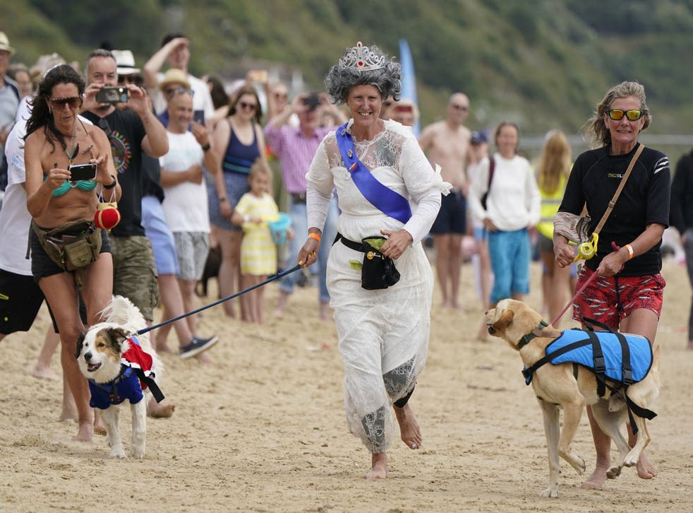 Ms Wilkinson races to the finish line with her dog Diogie (Andrew Matthews/PA)