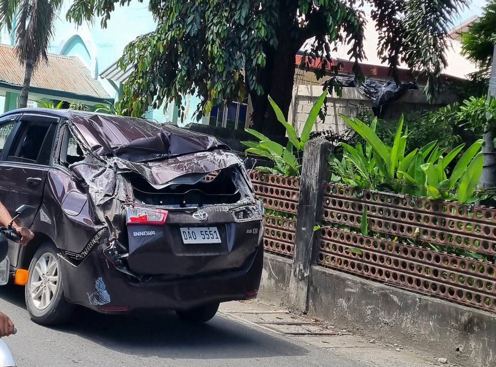 <p>A damaged car is seen along a road after a strong quake hit Bangued, Abra province</p>