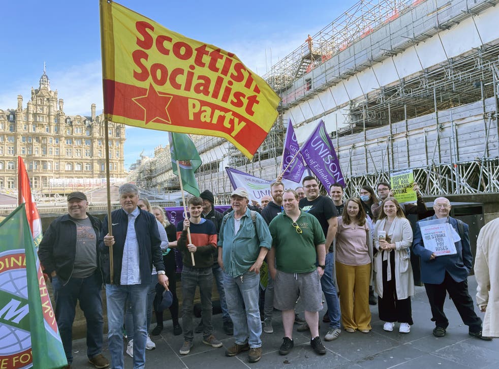 Members of the RMT on the picket line outside Edinburgh Waverley station (Katharine Hay/PA)