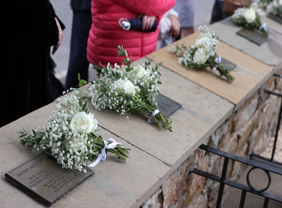 Flowers on memorial plaques at a service in Claudy (Liam McBurney/PA)