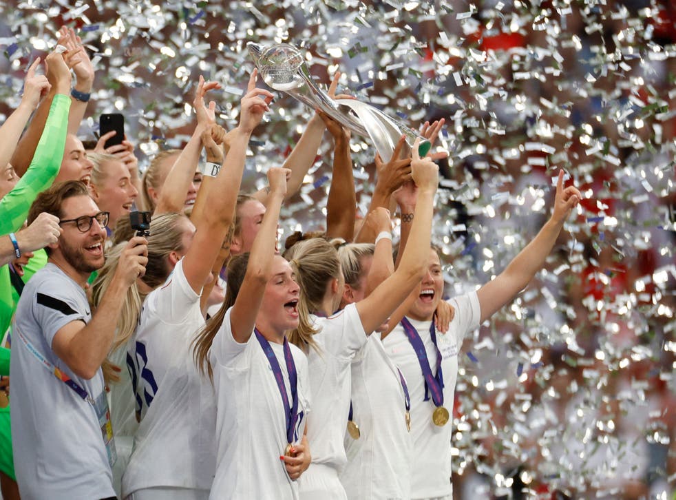 <p>Leah Williamson and Millie Bright lift the trophy as they celebrate with teammates after winning the Women’s Euro 2022</p>