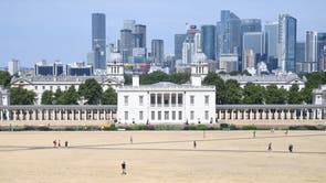 People walk on parched ground in Greenwich Park in London