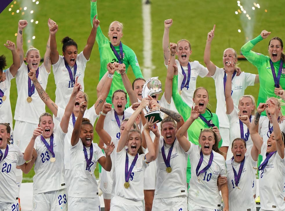 England’s Leah Williamson and Millie Bright lift the trophy as England celebrate winning the UEFA Women’s Euro 2022 final at Wembley Stadium (Joe Giddens/PA)