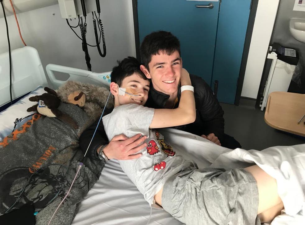 Daniel Greer and brother James hug in hospital (family handout)