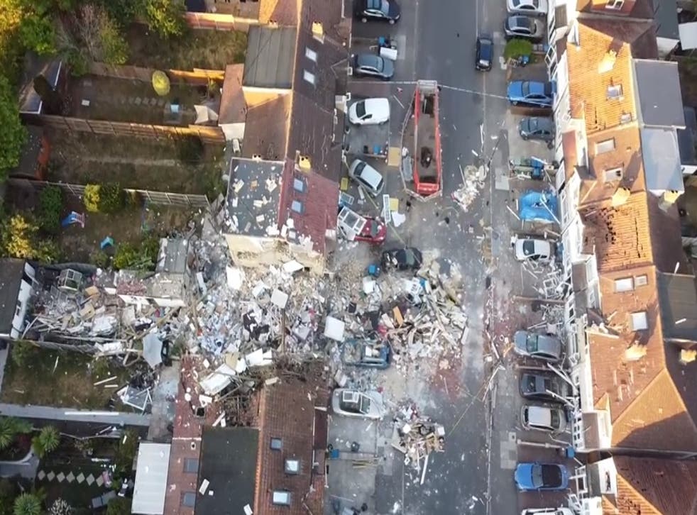 <p>Bricks, mortar and other debris can be seen strewn across the road at the front of the property</p>