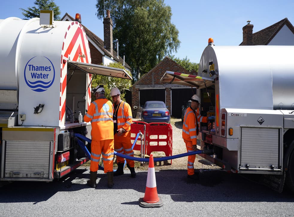 A tanker from Thames Water pumps water into another tanker in the village of Northend (Andrew MAtthews/PA)
