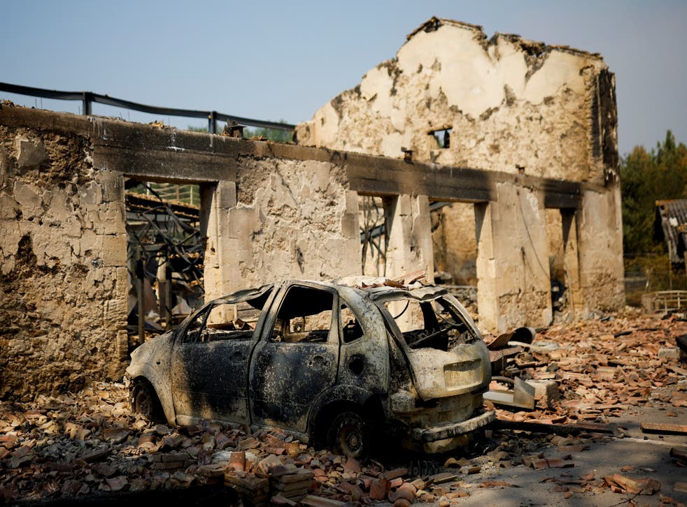 <p>A view of a house and a car destroyed by fire in Belin-Beliet, as wildfires continue to spread in the Gironde region of southwestern France</bl>