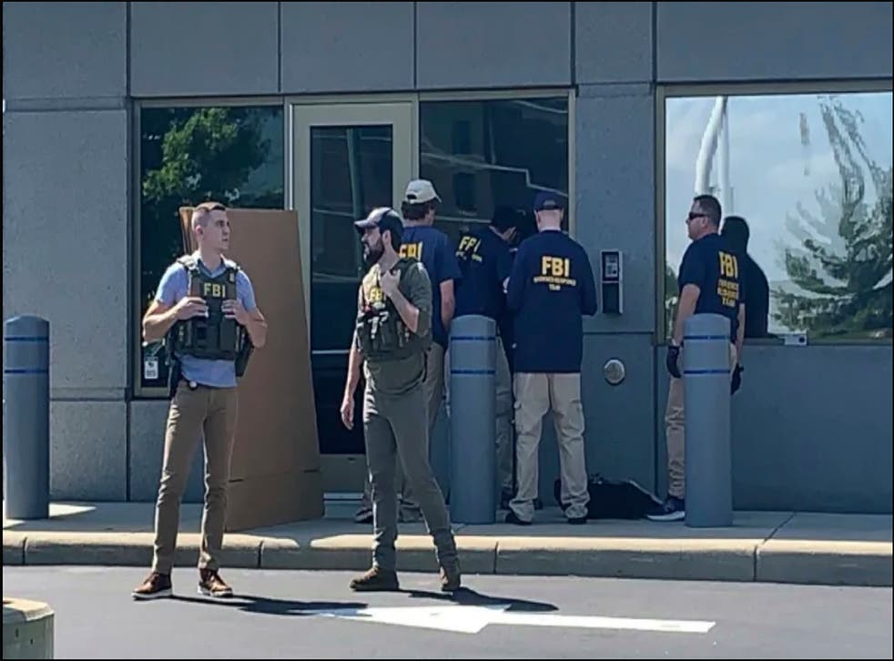 <p>Officials gather outside the FBI building in Cincinnati, after Shiffer attempted to breach the building </s>
