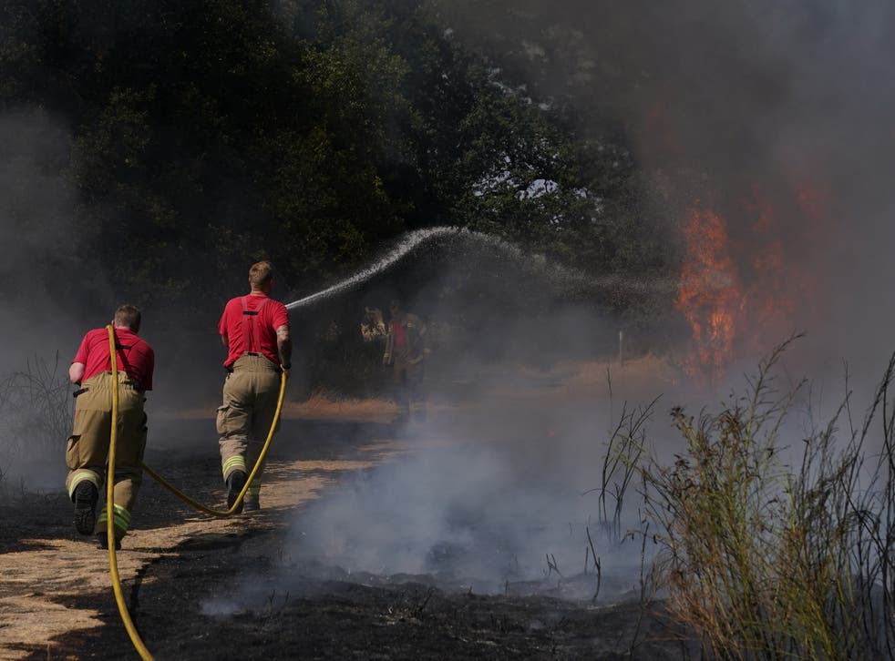 Firefighters battle a grass fire on Leyton Flats in east London, as a drought has been declared for parts of England following the driest summer for 50 years (Yui Mok/PA)