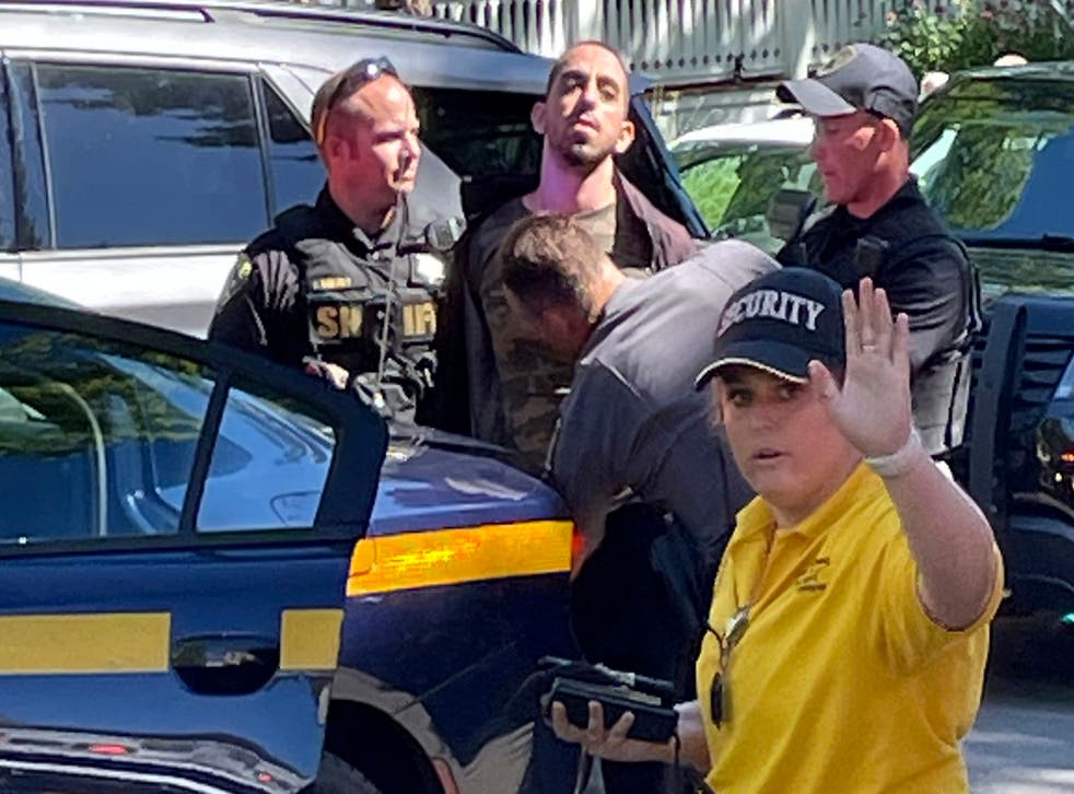 <p>Law enforcement officers detain a person outside the Chautauqua Institution</磷>