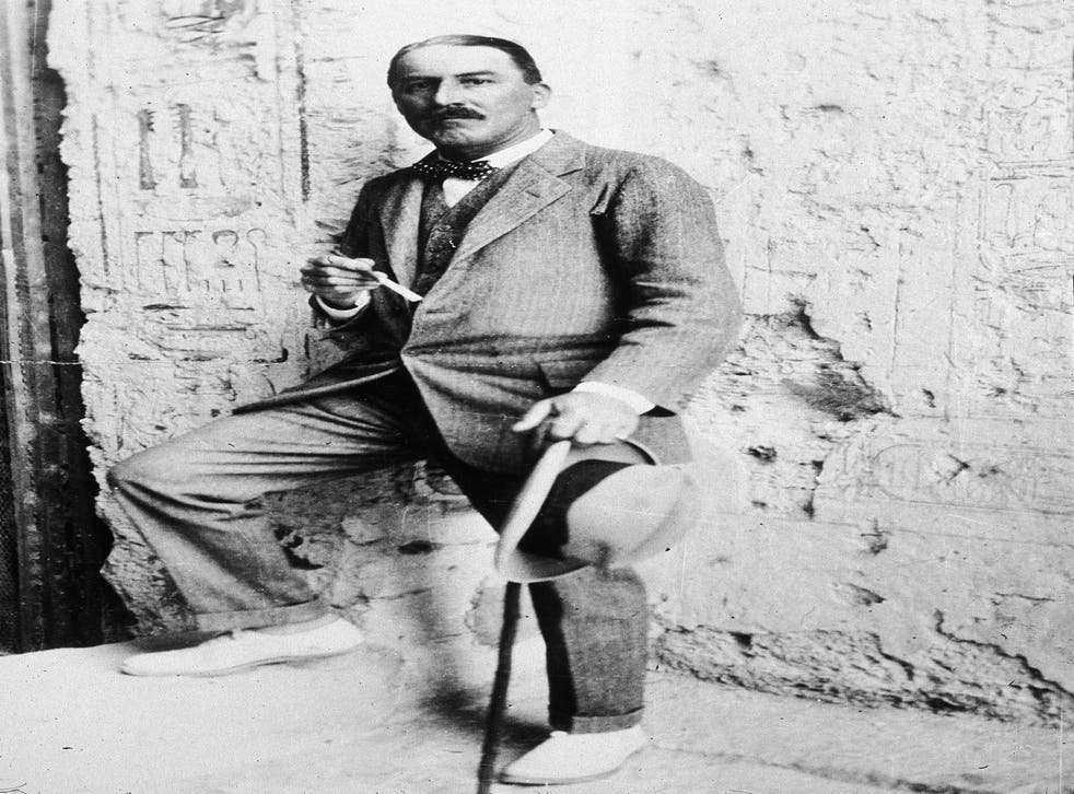 <p>British Egyptologist Howard Carter stands with one foot up on a step at the entrance to an Egyptian archaeological site in 1923</p>