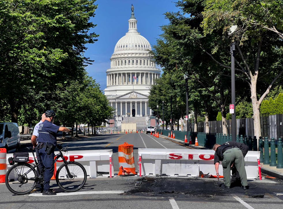 <p>US Capitol Police Officers work near a police barricade on Capitol Hill in Washington, DC, em agosto 14, 2022</p>