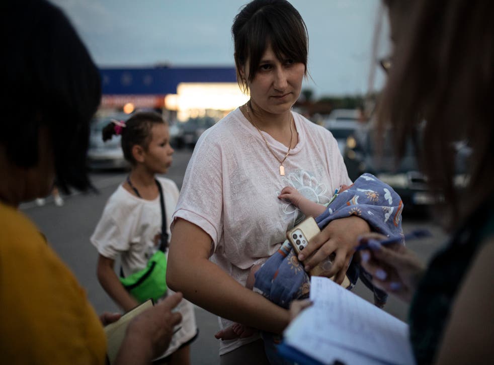 <p>Elena Ovchinnikova, 27, holds her newborn, David, after arriving at a center for displaced people</p>
