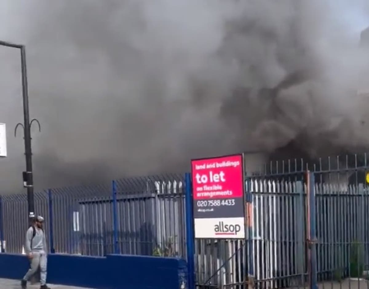 London train services disrupted as 70 firefighters tackle huge blaze near railway