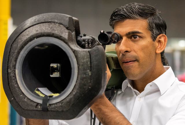 Rishi Sunak looks at a NLAW anti tank launcher, supplied to Ukraine, during a campaign visit to Thales Defence System plant in Belfast, as part of his campaign to be leader of the Conservative Party and the next prime minister
