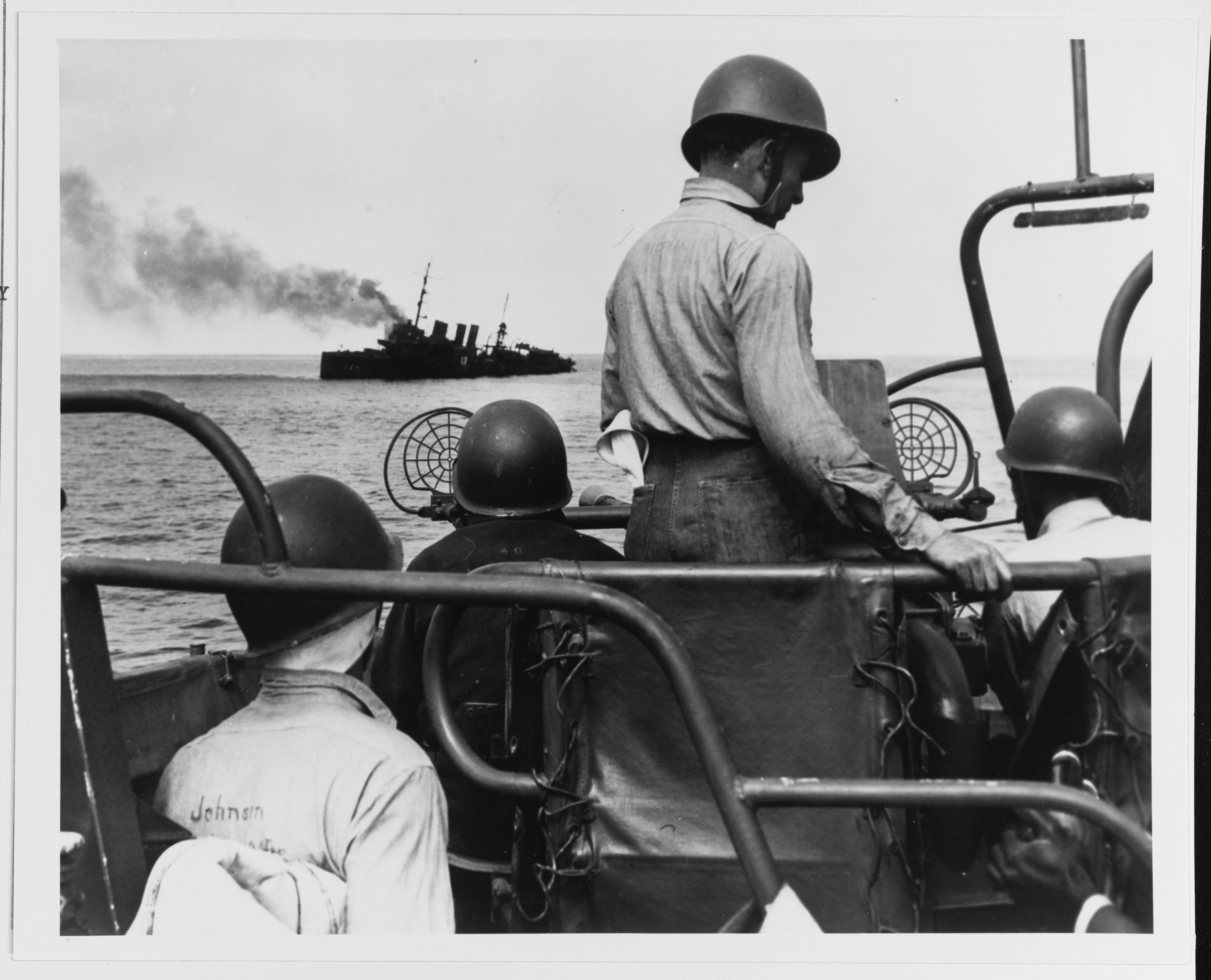 Photo shows sailors watching as the USS Stewart was sunk on 24 May 1946