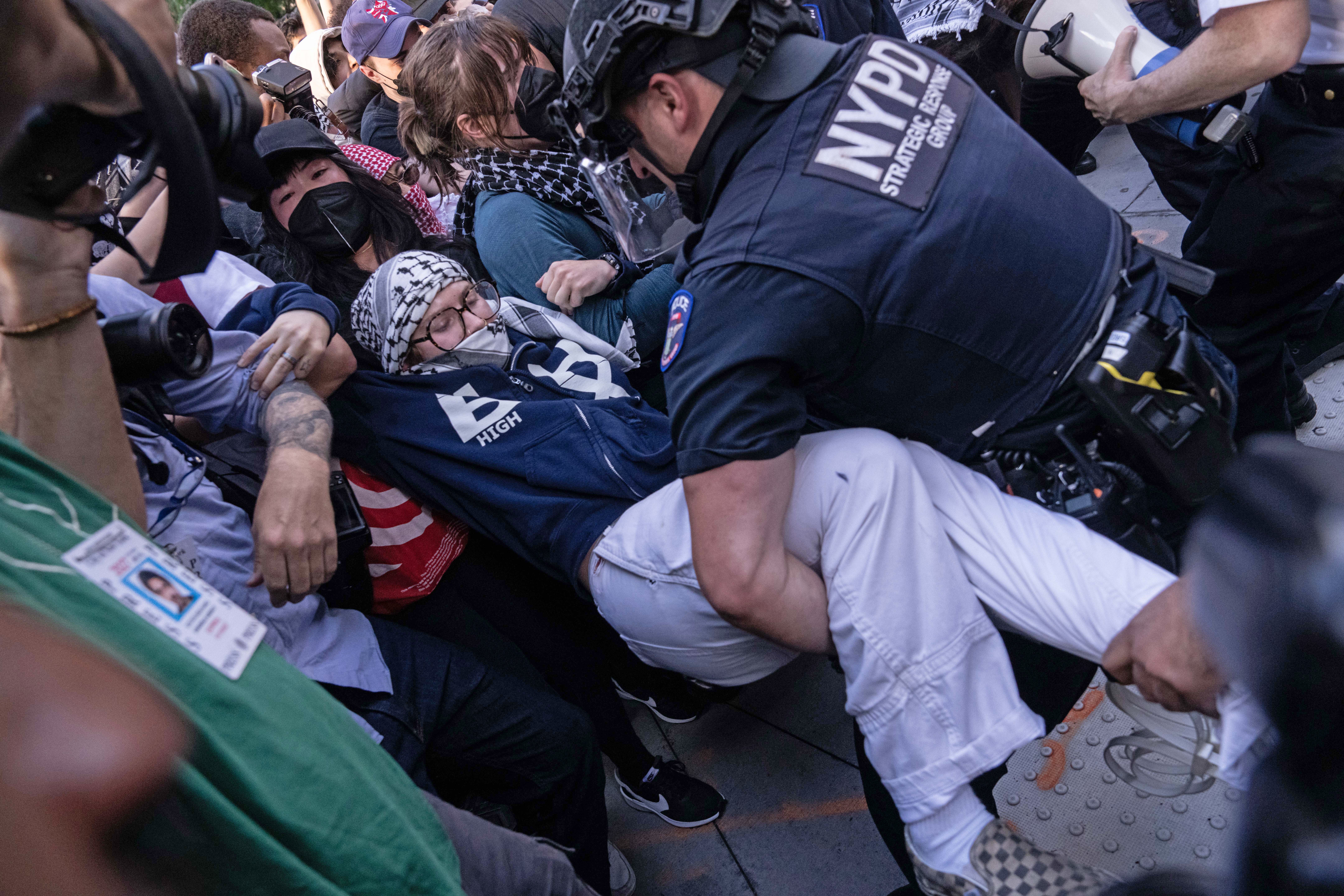 NYPD Strategic Response Group officers make arrests as people protest against deportations and ICE outside of federal buildings on Tuesday in New York City