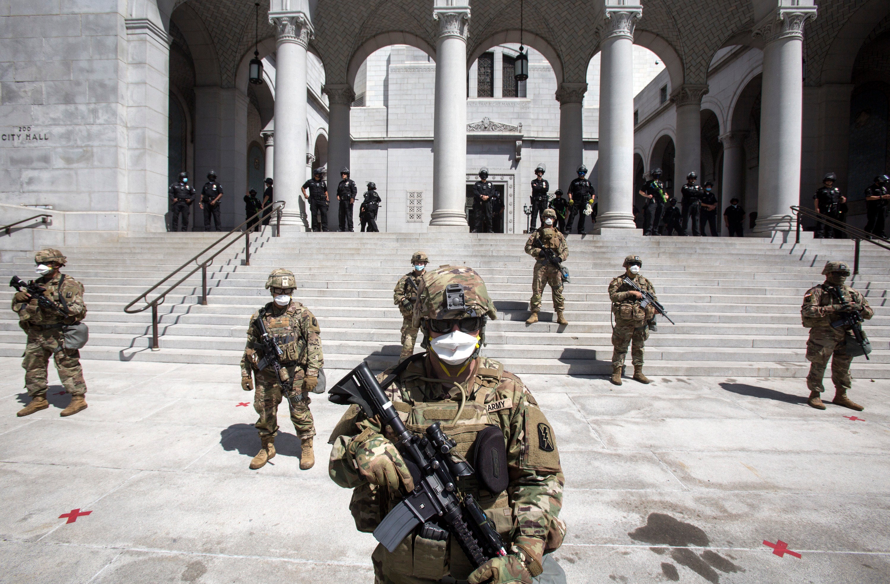 Members of the California National Guard stand guard outside the Los Angeles City Hall on May 31, 2020, as protests raged following high-profile police killings.