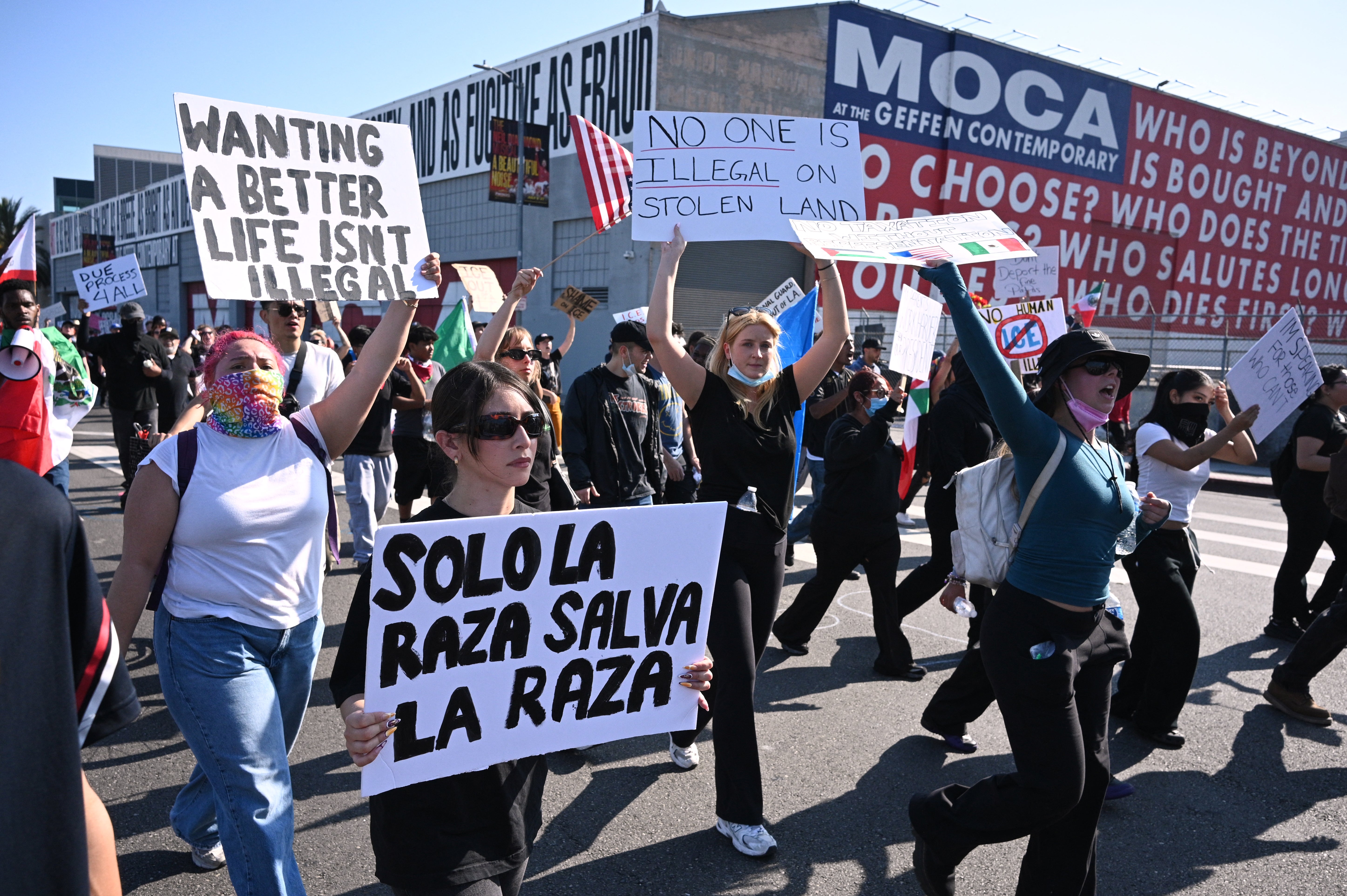 A woman holds a sign with the words,
