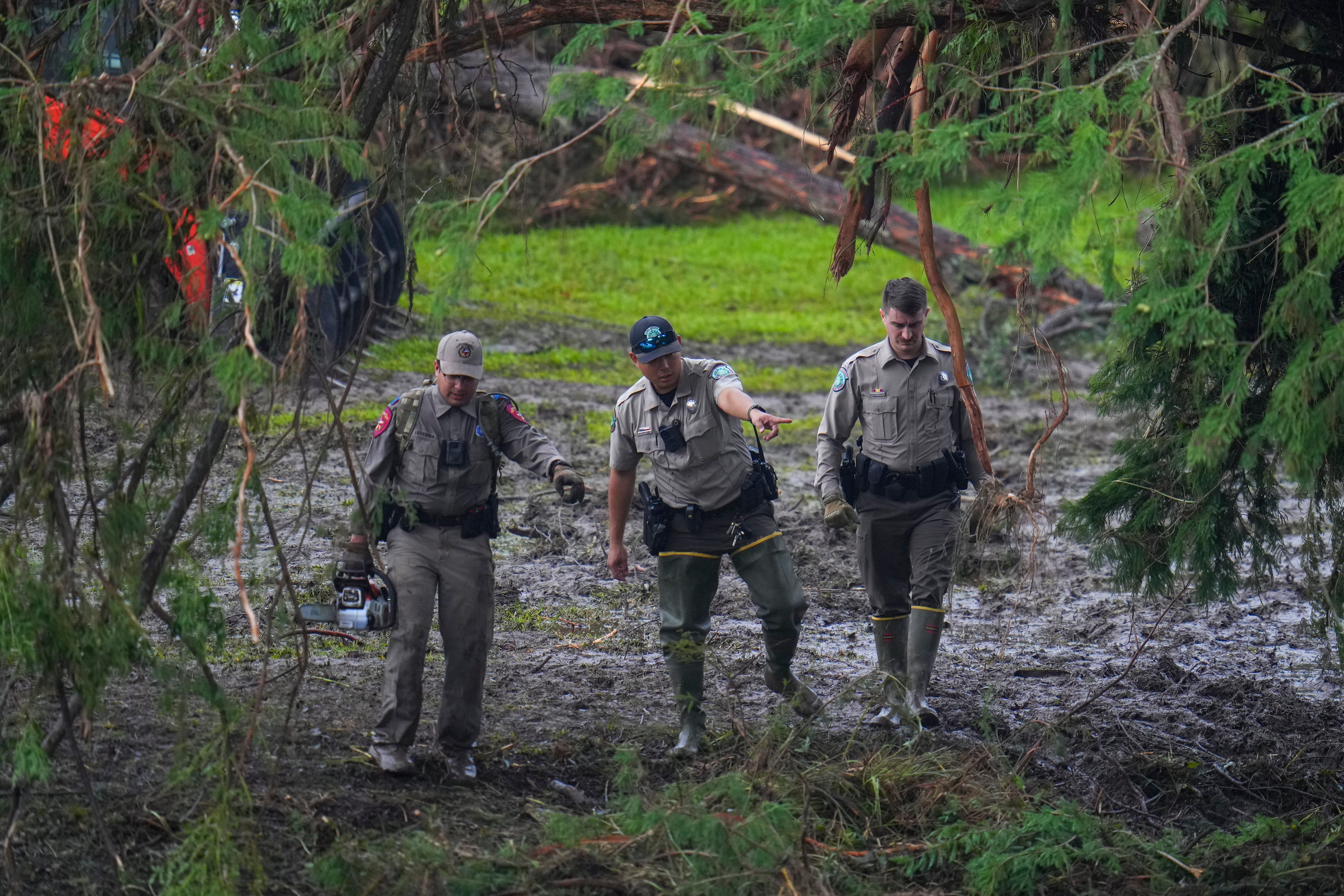 Officials inspect an area at Camp Mystic along the banks of the Guadalupe River after a flash flood swept through the area Sunday, July 6, 2025, in Hunt, Texas. (AP Photo/Julio Cortez)