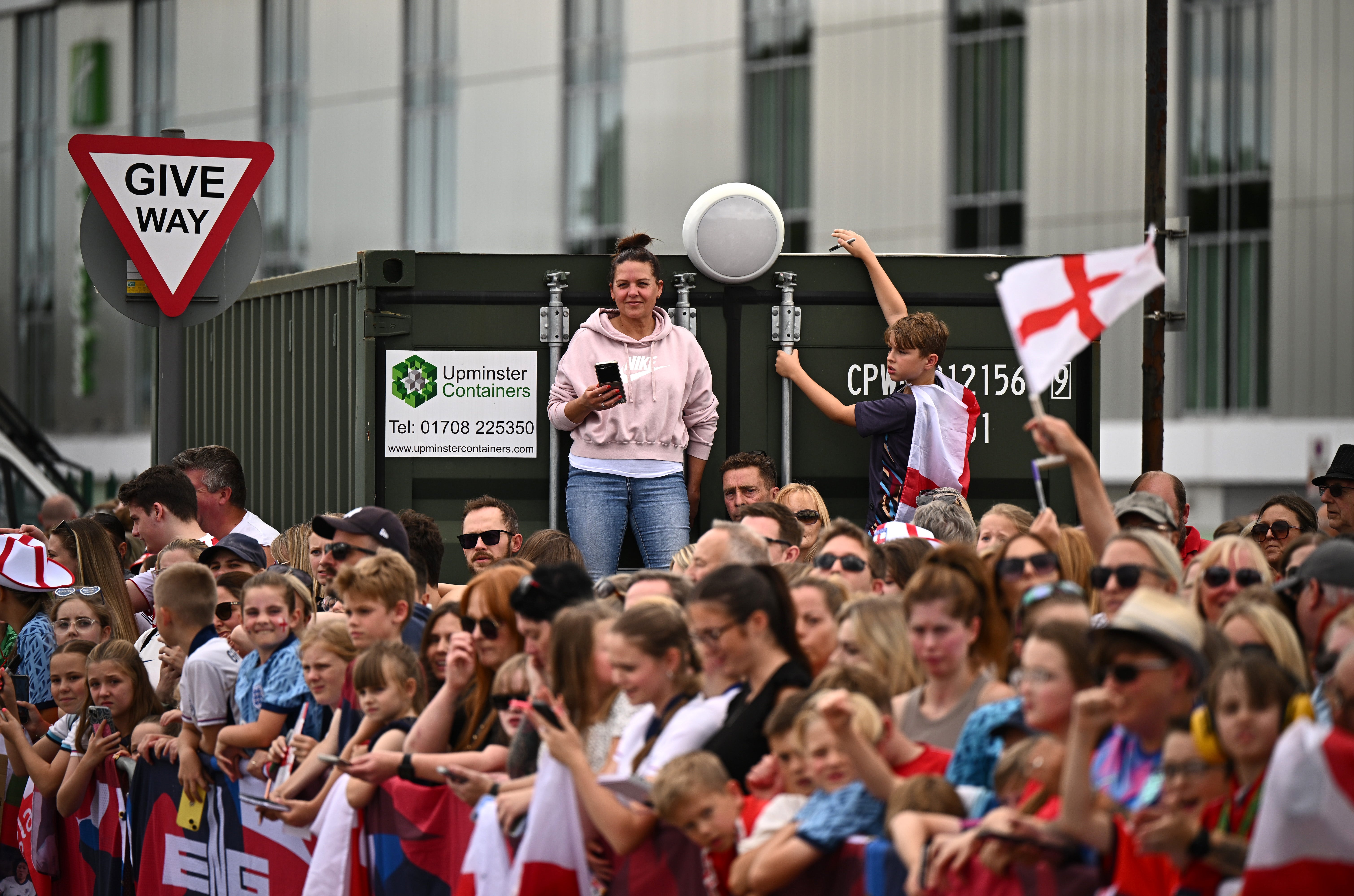 Fans stand on a container to get a view as they wait for the England Women's Squad to arrive back at Southend Airport